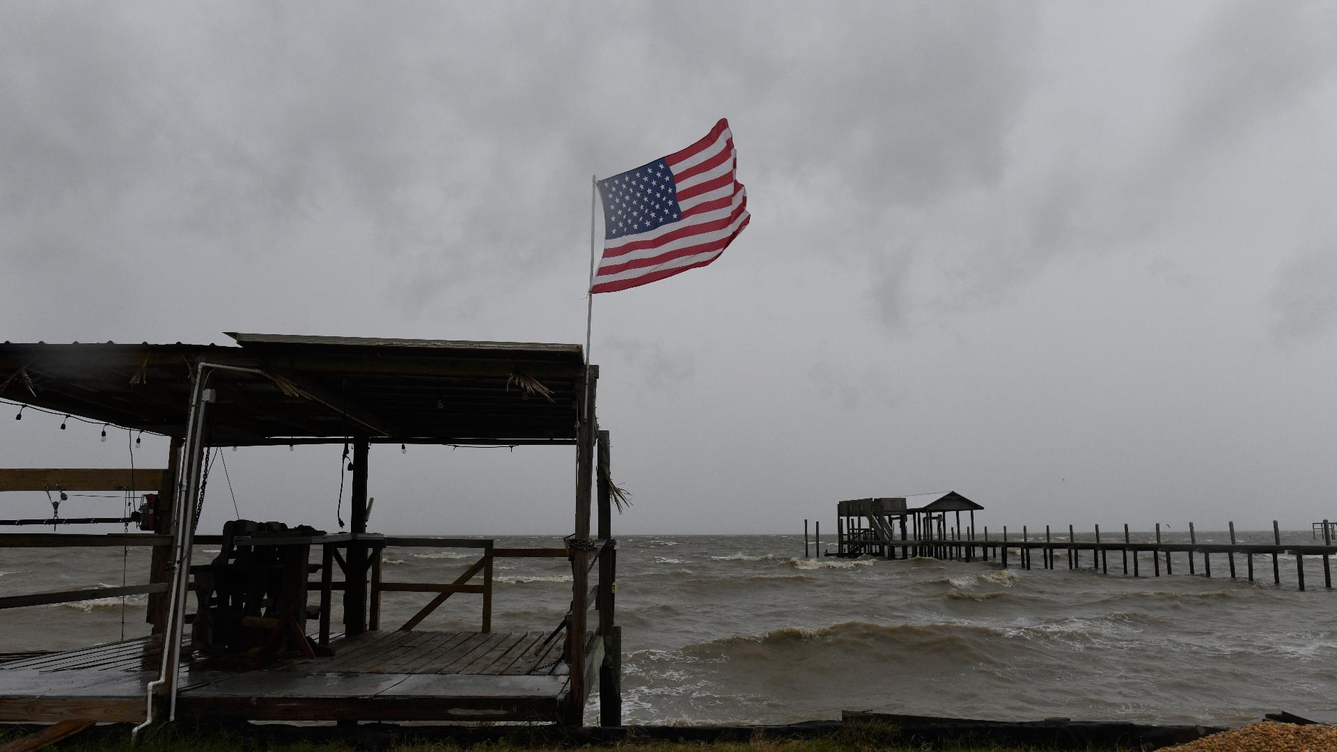 Isaias weakens but flooding threats persist as hundreds of thousands grapple with power outages