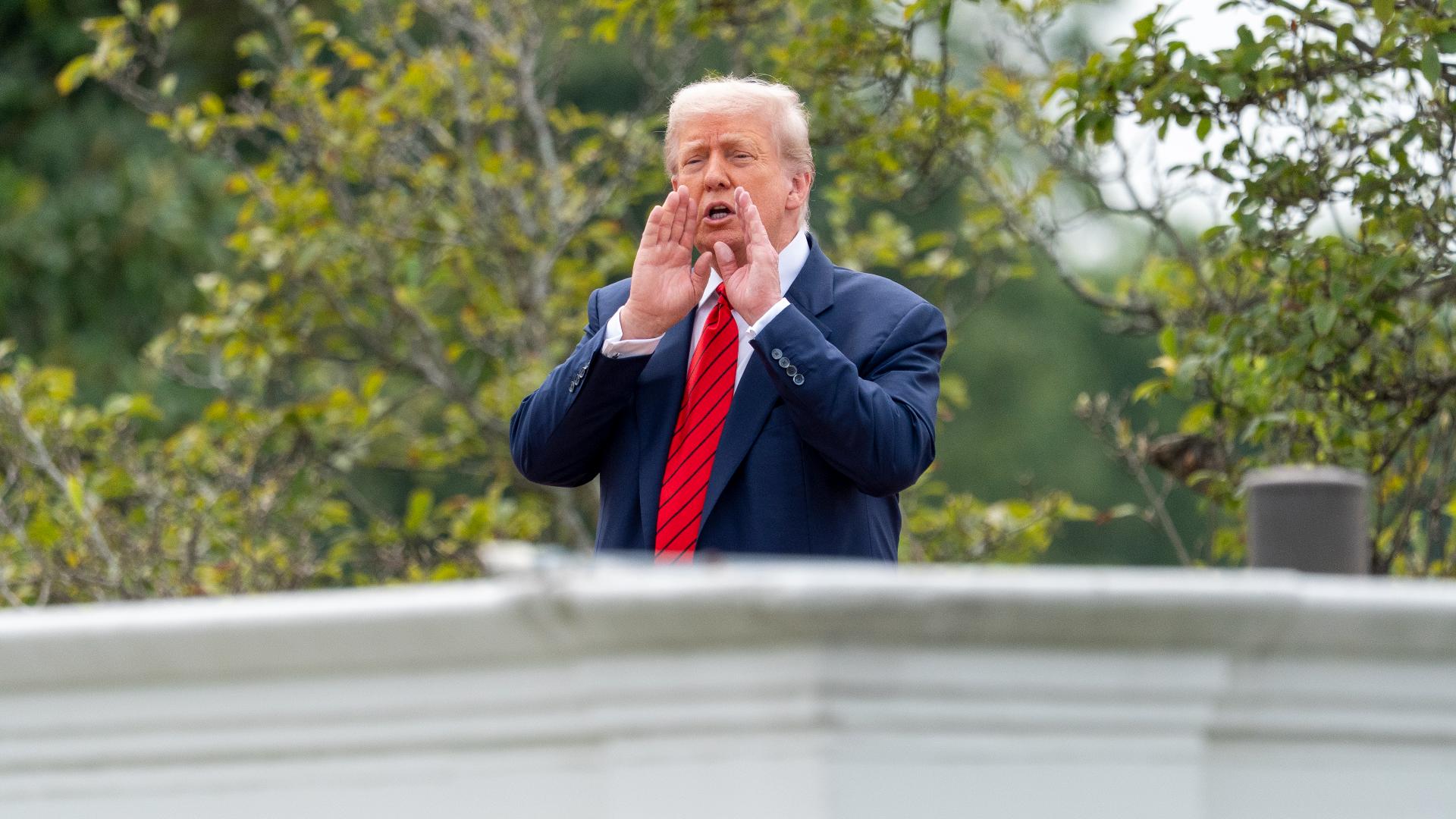 Trump popped out on the roof of the White House West Wing Tuesday morning, appearing to take stock of several areas including the Rose Garden.