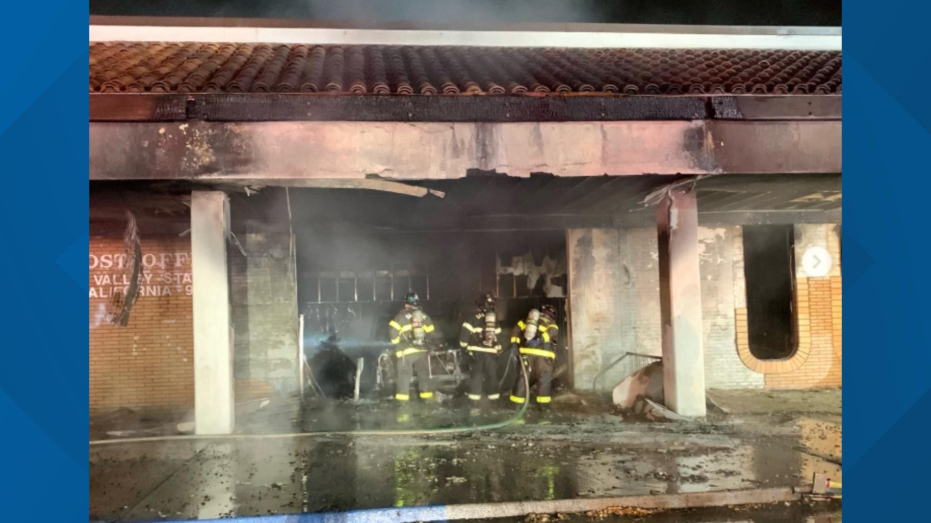 A suspect was arrested after a car crashed into a post office in San Jose, California, early Sunday, causing the building to go up in flames, authorities said.