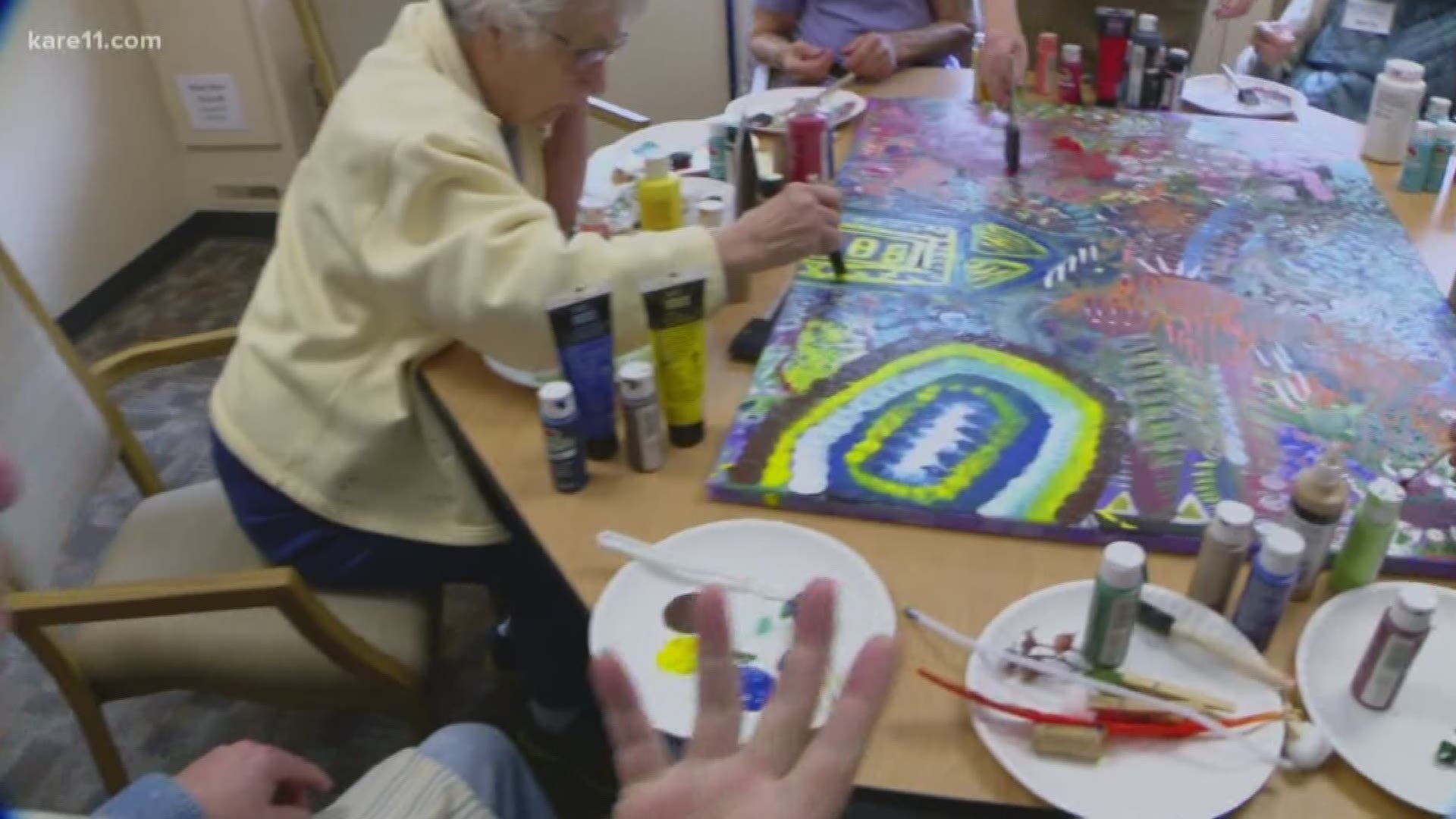 Open Circle members are currently working on an art piece that will hang on the wall at ICA Food Shelf in Minnetonka.