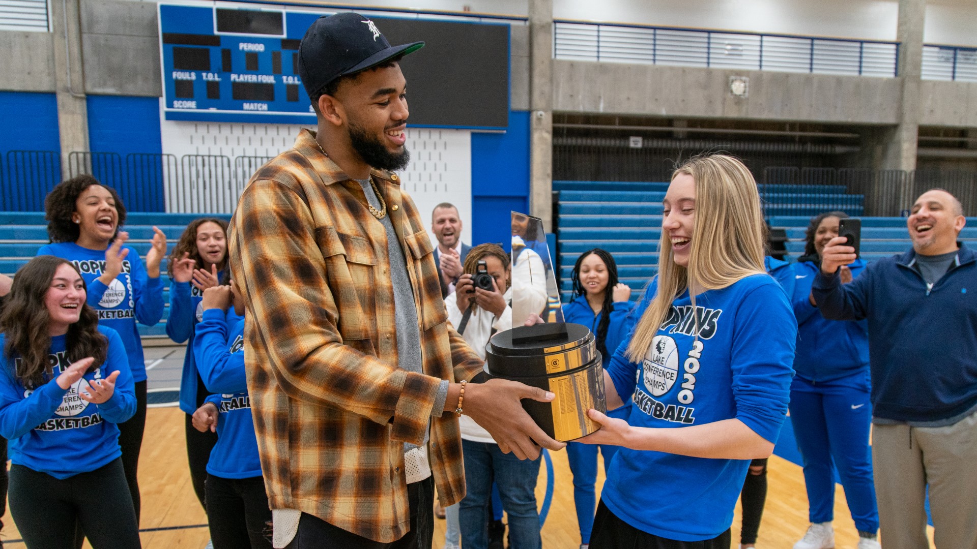 The Minnesota Timberwolves' Karl-Anthony Towns presented the Gatorade National Girls Basketball Player of the Year award to Hopkins senior Paige Bueckers.