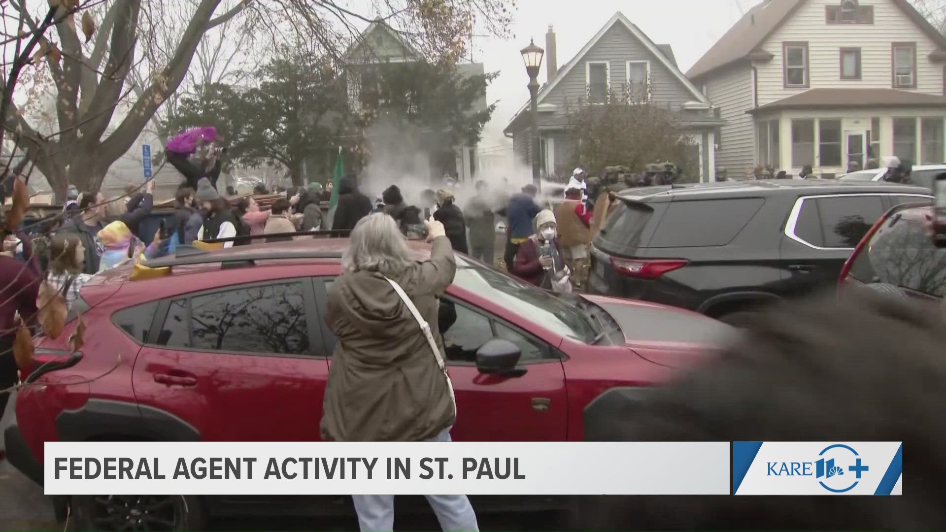 Federal agents - including those with ICE logos - are centered at a house in St. Paul. 