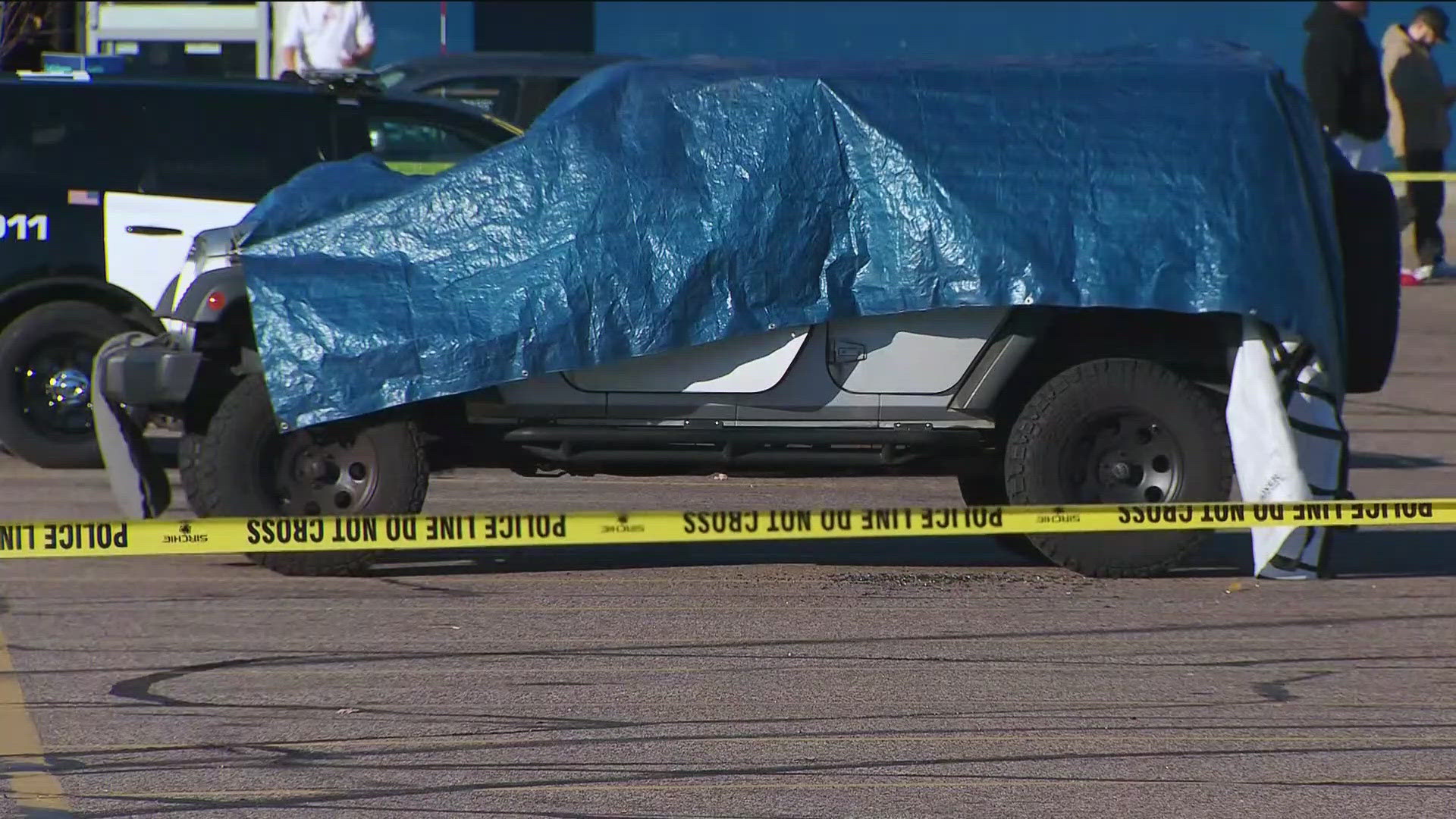 Police say both adults had gunshot wounds and that a firearm was found inside the vehicle.