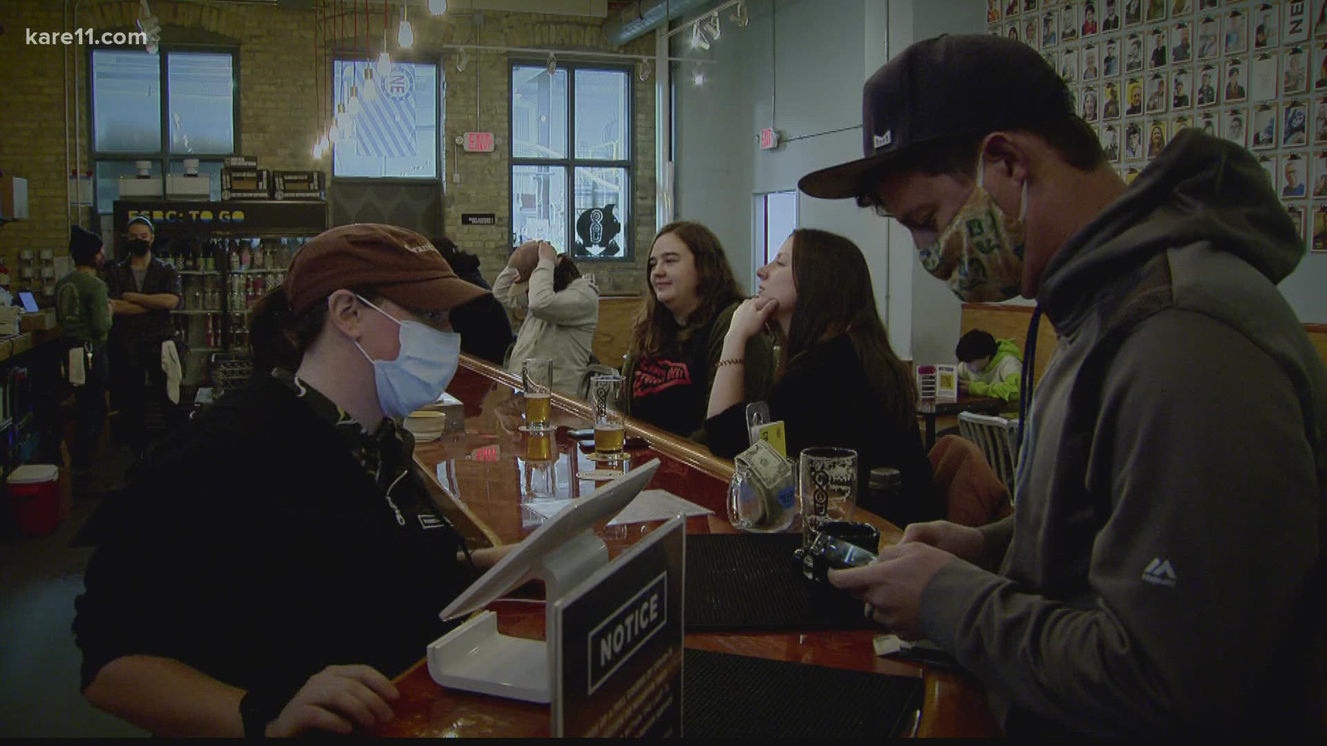 Twin Cities' businesses that serve food and beverages indoors will require patrons to show a vaccination card or a negative test before they enter.