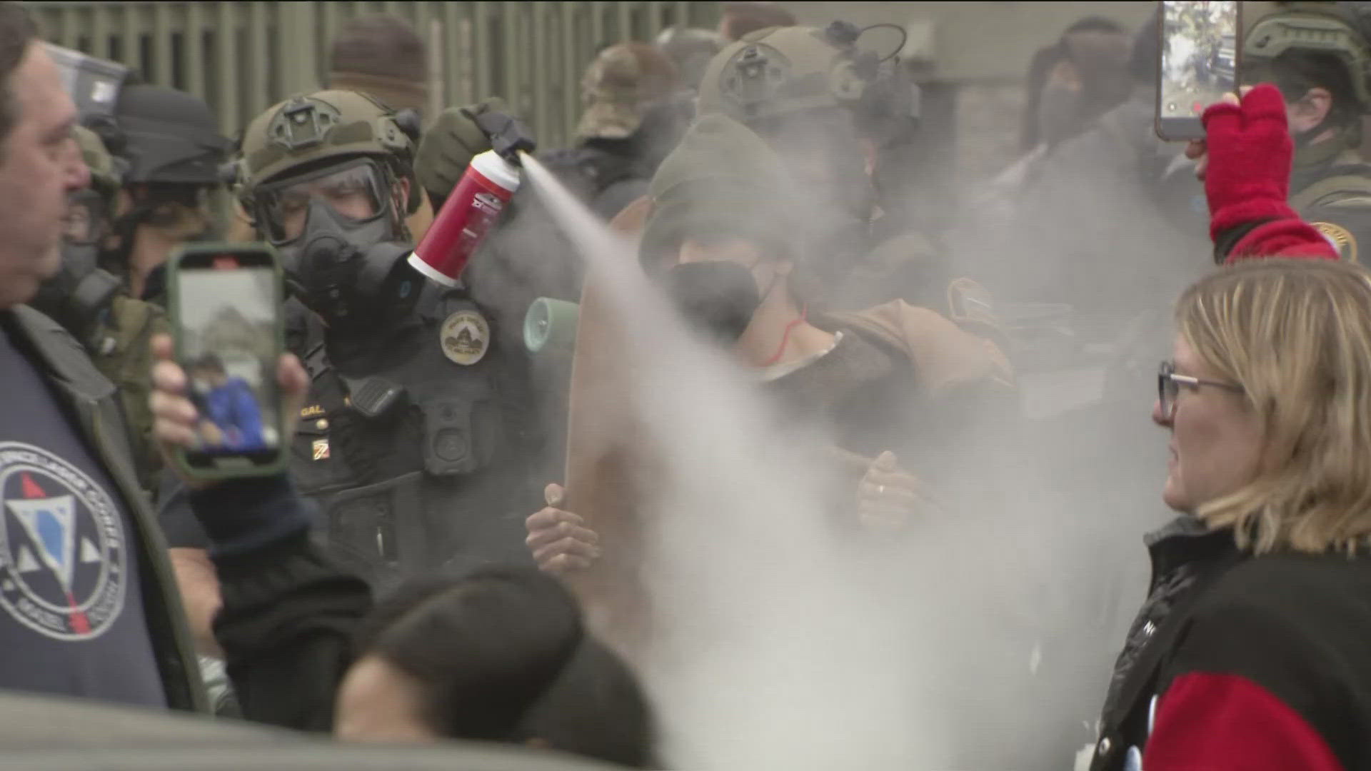 A witness said the number of agents kept growing, as did an angry crowd that was eventually sprayed with chemical irritants.