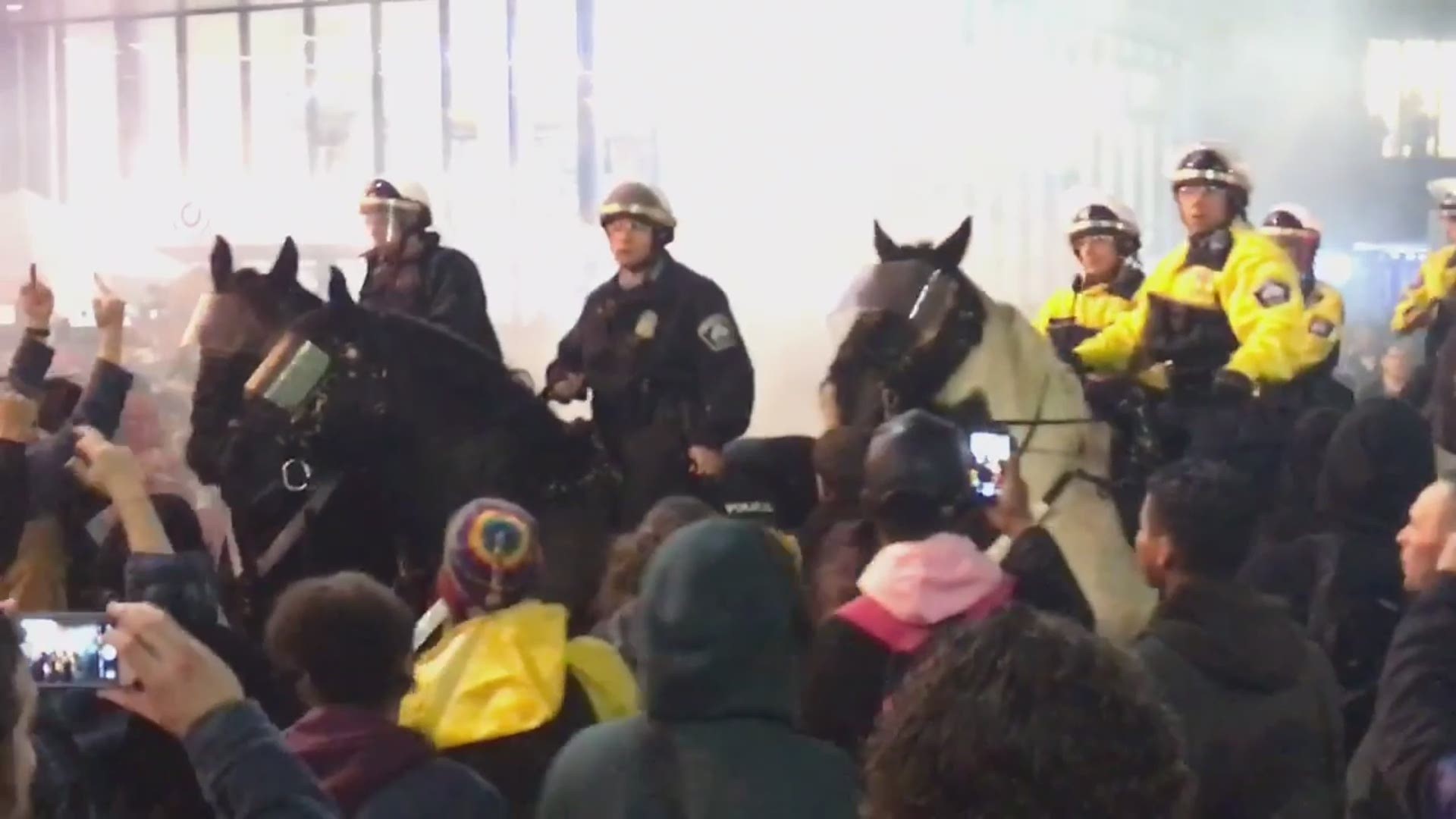 Police on horses in the crowds outside Target Center during the Trump rally in Minneapolis