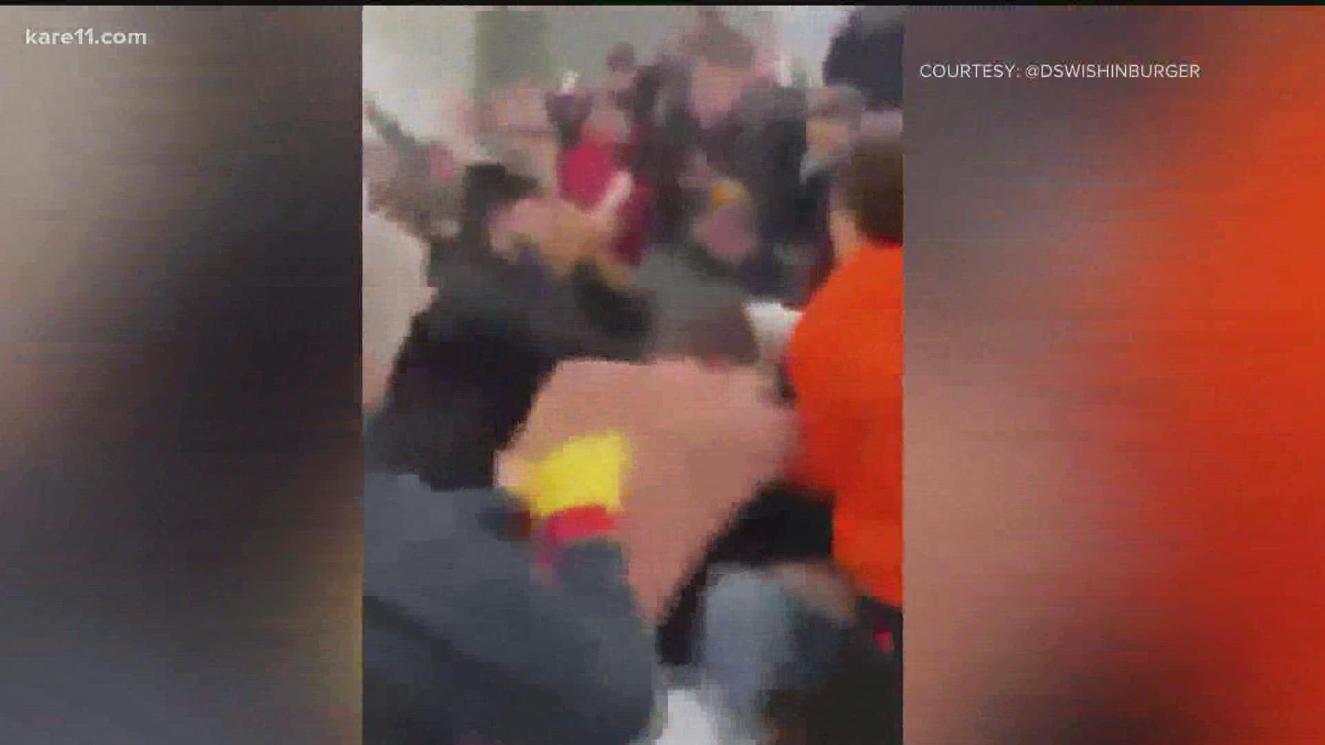 It's hard to pinpoint who exactly was involved in the fight, but witnesses say an adult got into an altercation with students in the White Bear Lake student section.