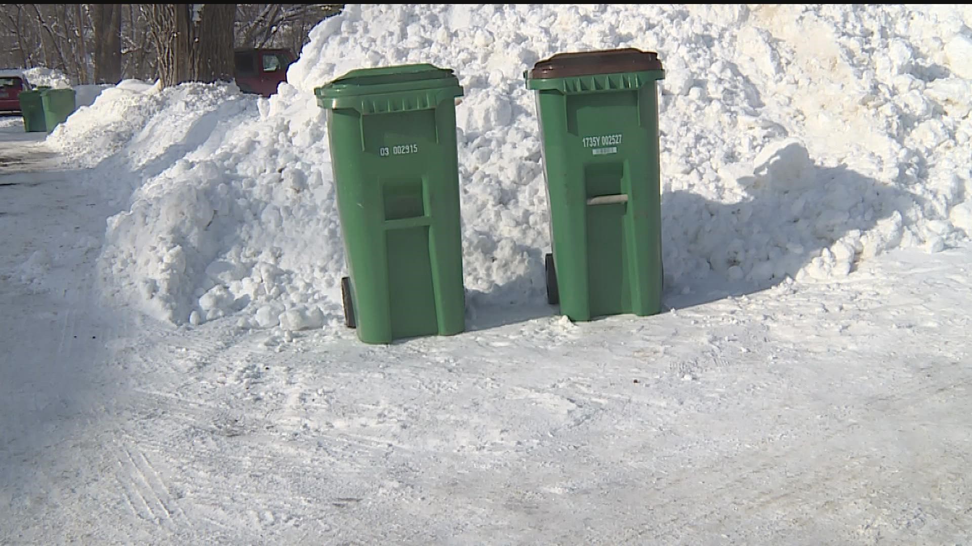 Many cities require residents to shovel out a 3-foot-wide path for garbage bins, but city leaders say several bins are still stuck in the snow.