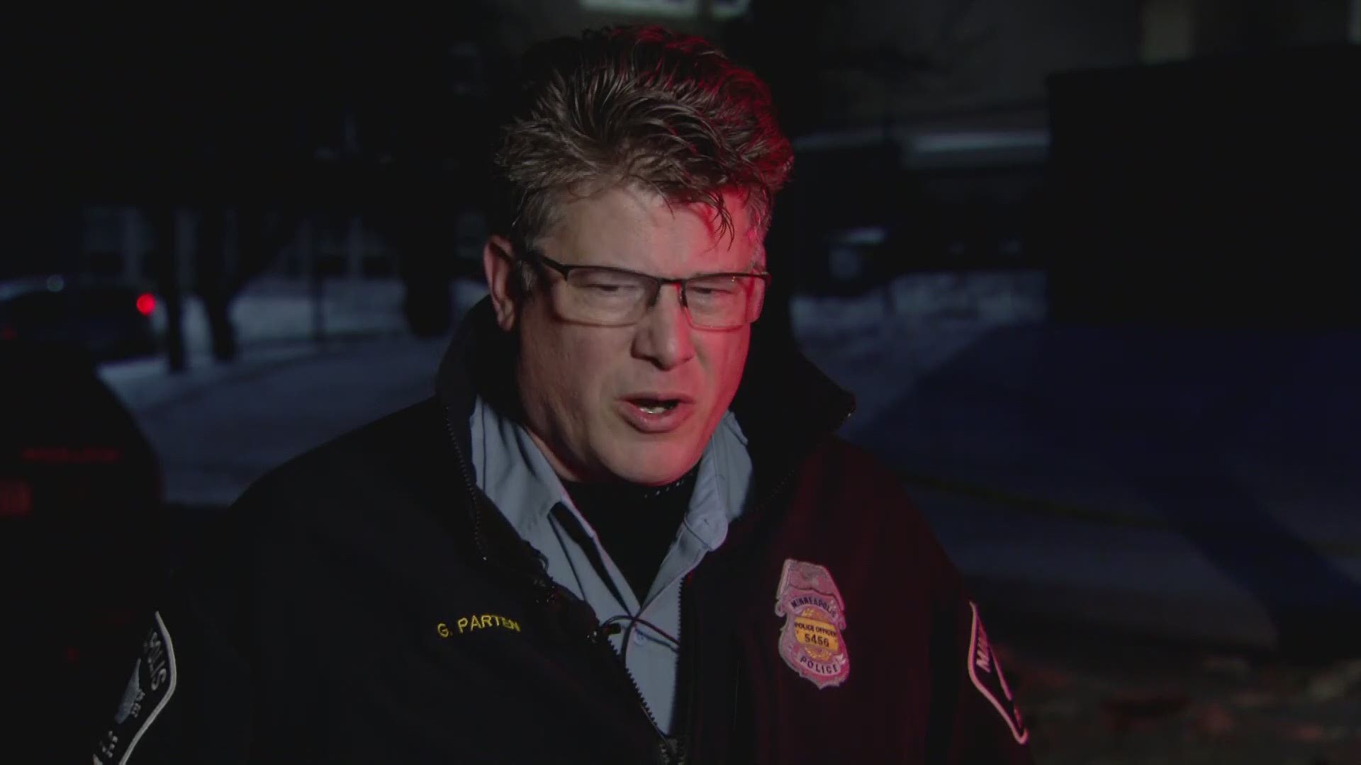 Minneapolis Police spokesman Garrett Parten provides information to a homicide on Russell Ave. North.