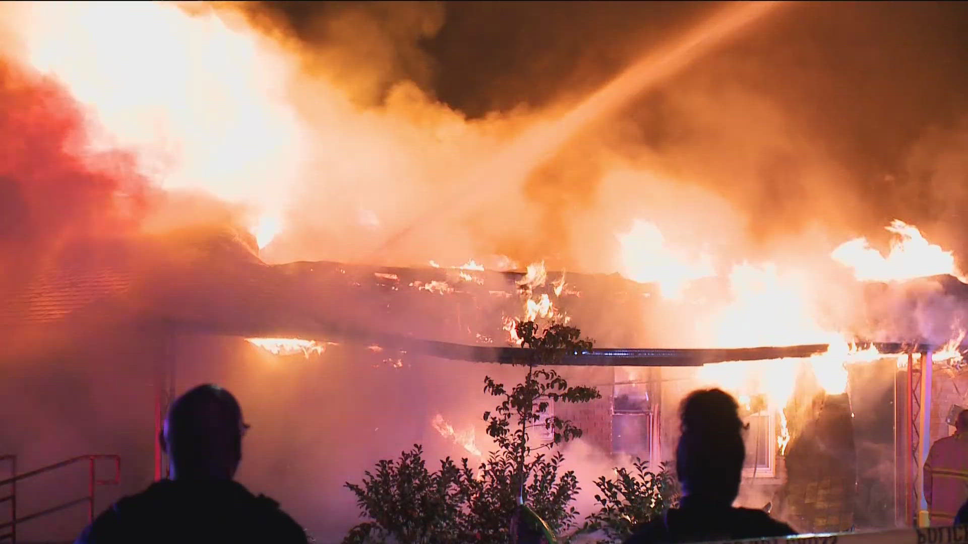 Fire officials say the flames started in a garage but then jumped to an apartment building and hotel.