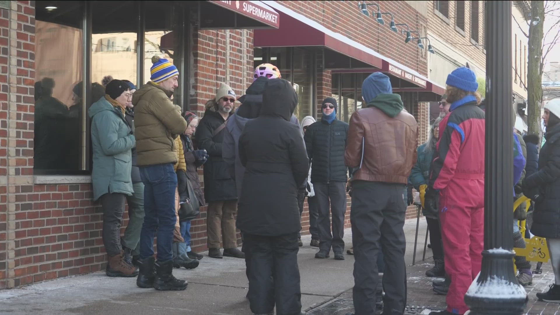 Neighbors gathered outside of Holy Land on Central Avenue in solidarity with immigrant-owned businesses.