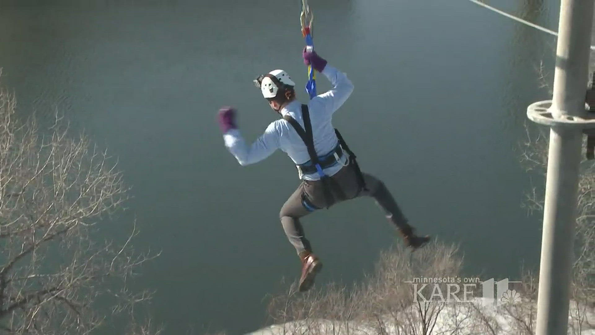 People of all ages are zip lining across the freezing Mississippi as part of Super Bowl Live.