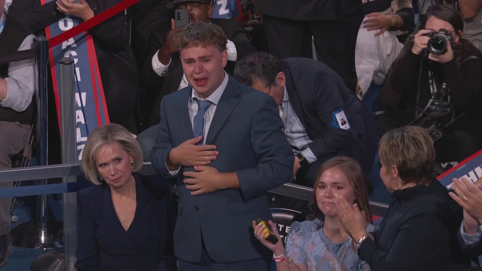 Gus Walz gets emotional while his father, Tim Walz, speaks during the Democratic National Convention.