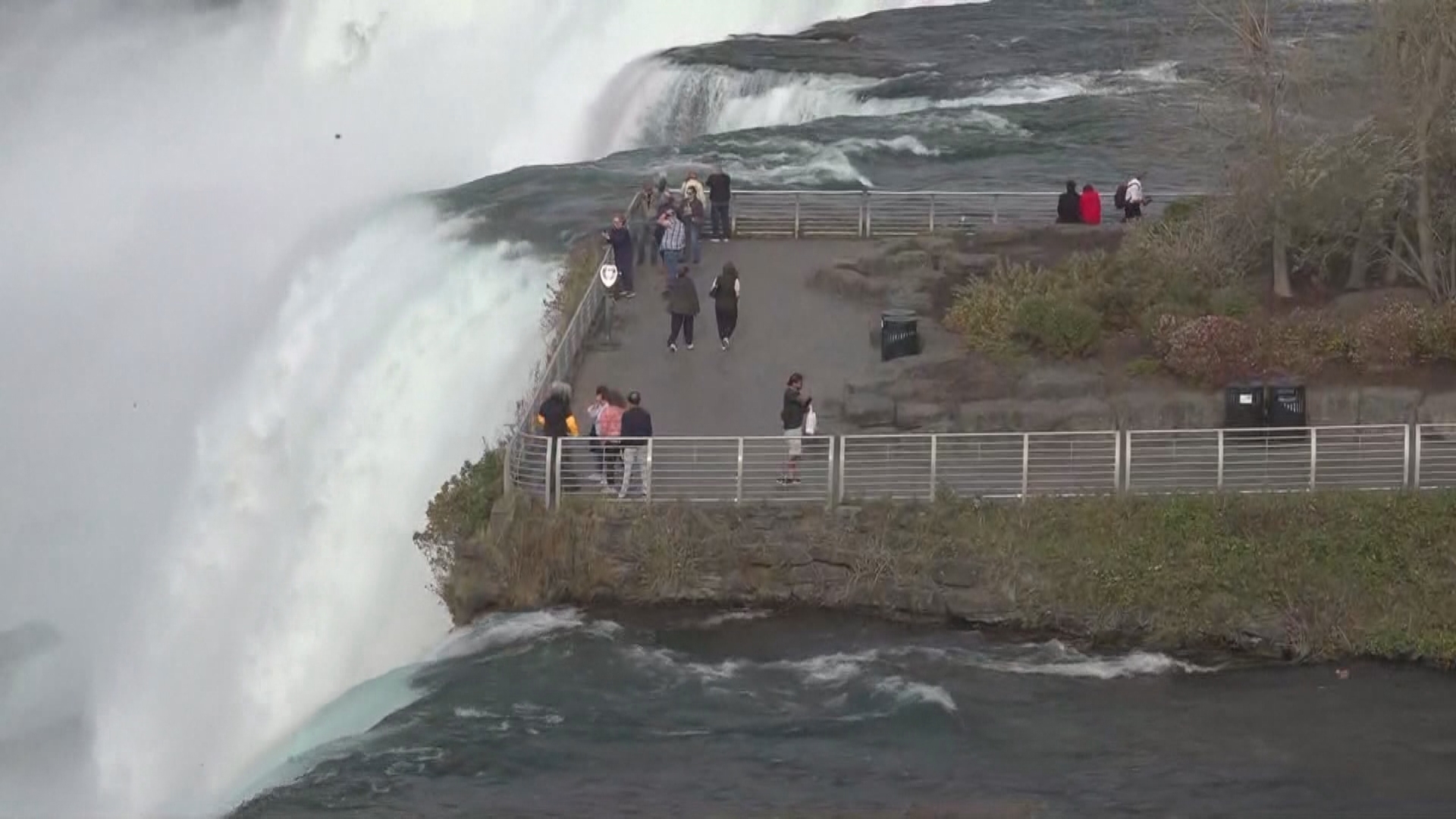 New York State authorities confirm that a woman and two children went over a guard rail and into the falls Monday night. They have not been found.