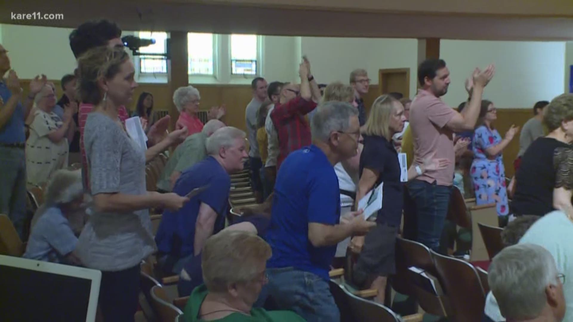 The defrocked pastor of an expelled Minneapolis church returned to the pulpit Sunday to a standing ovation from his congregation.