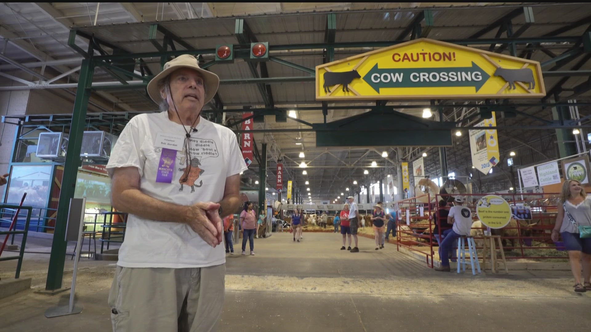 A retired software developer turned volunteer, Bob Gordon, tells cow jokes at the Minnesota State Fair's cattle barn.