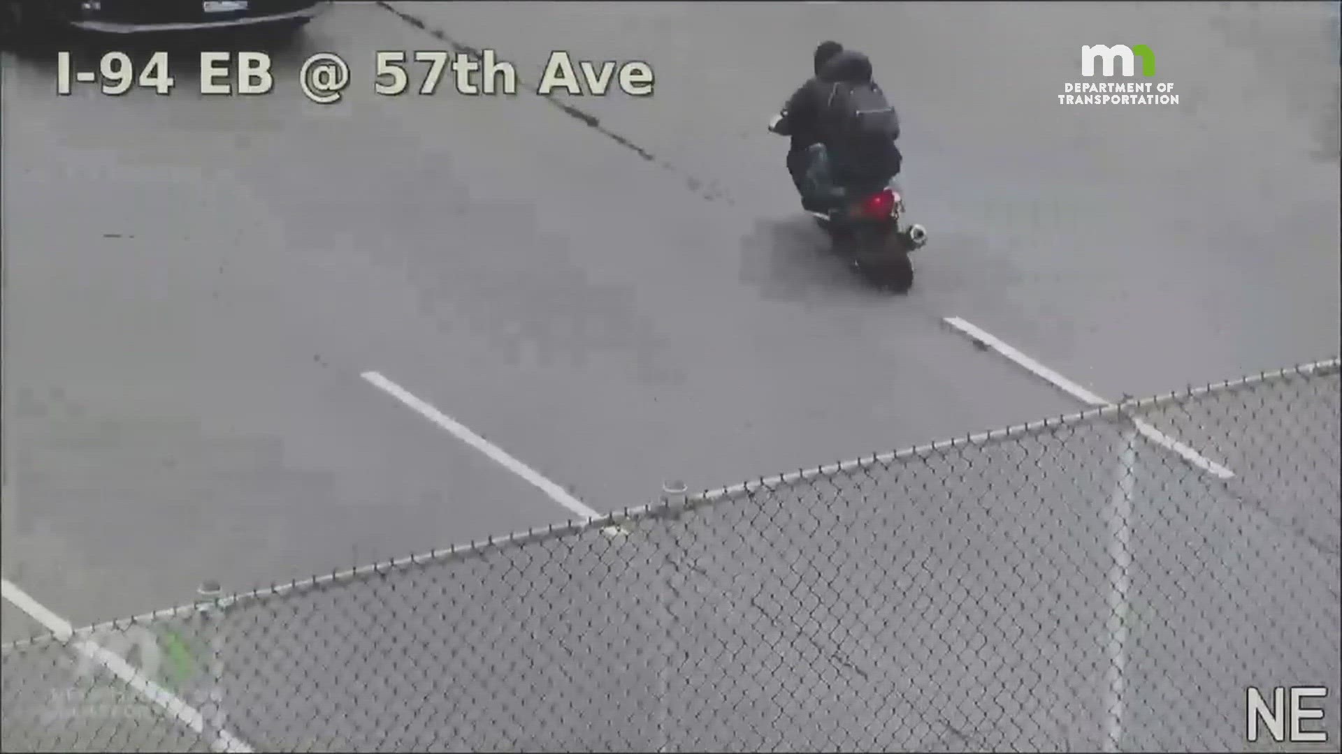 MnDOT traffic cameras first picked up the scooter guy riding directly into traffic. Eventually he ditched the two wheels and jumped on a trailer being towed.