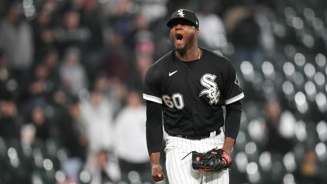 Chicago White Sox's Eloy Jimenez, left, celebrates with Luis Robert Jr.,  right, after they score on a two-run home run by Jimenez during the seventh  inning in the first baseball game of