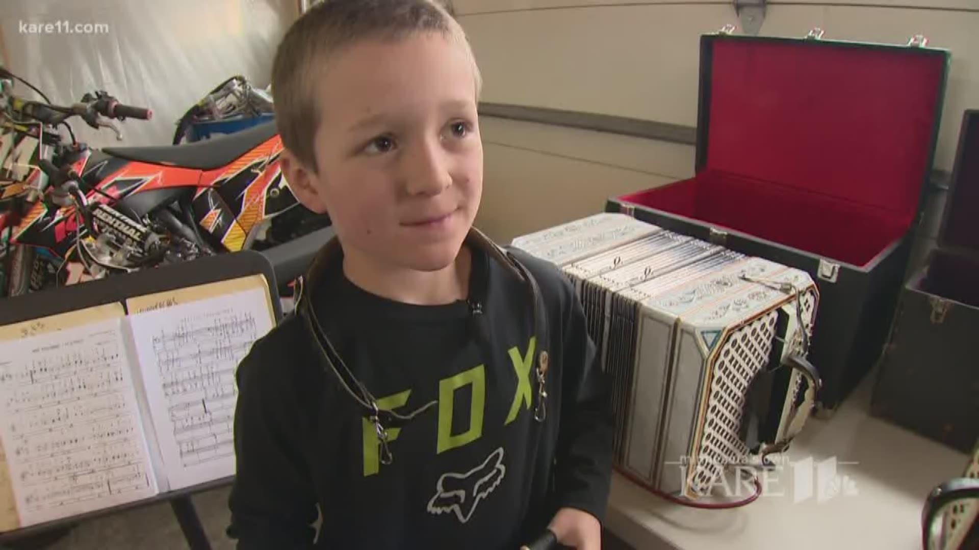 Young boy rocks concertina and lederhosen