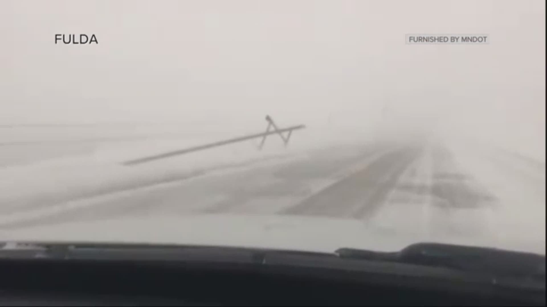 MnDOT tweeted video showing power poles on the ground lining Highway 59.