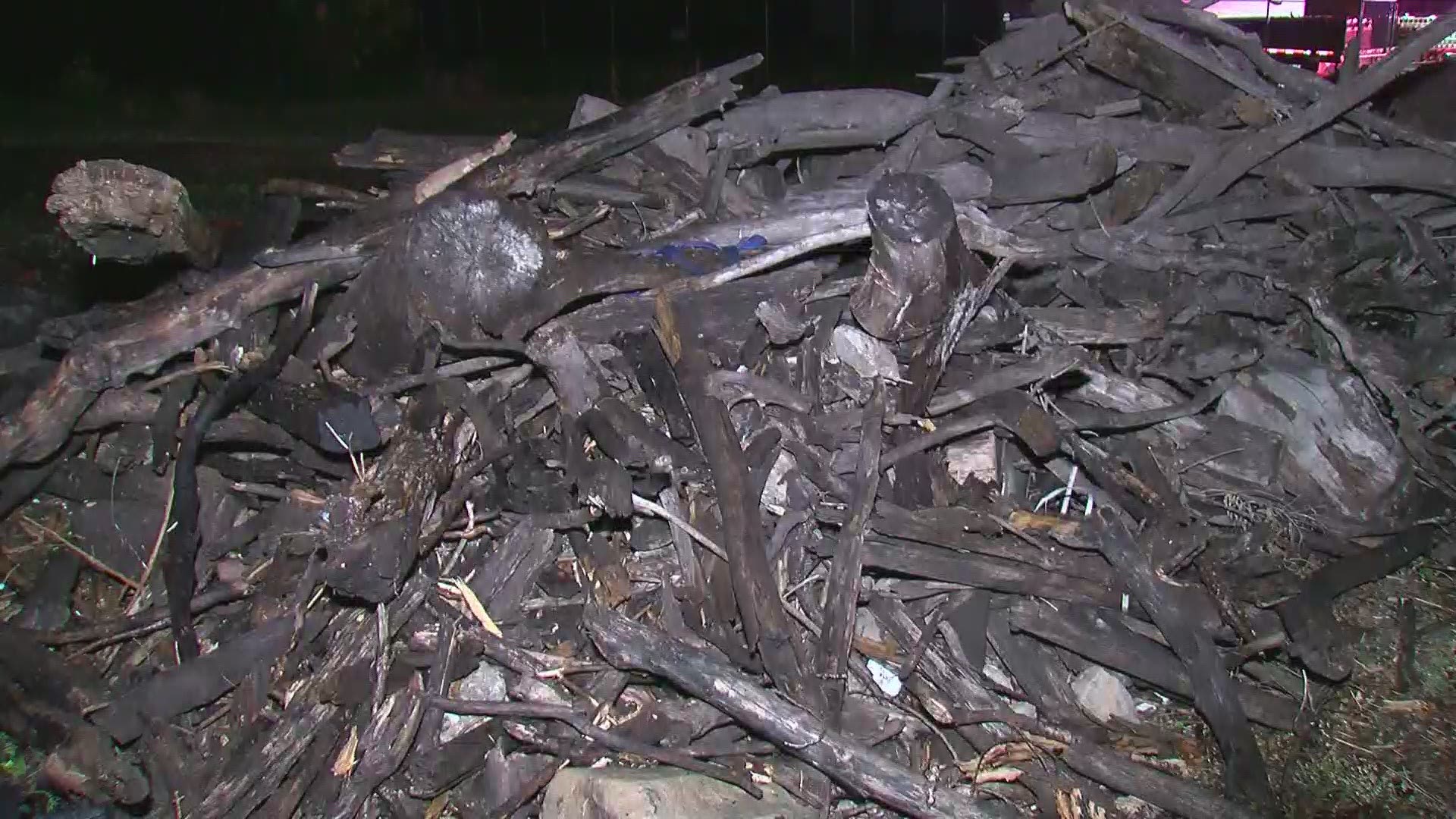 This video shows the aftermath of a blaze in a large pile of tree limbs.