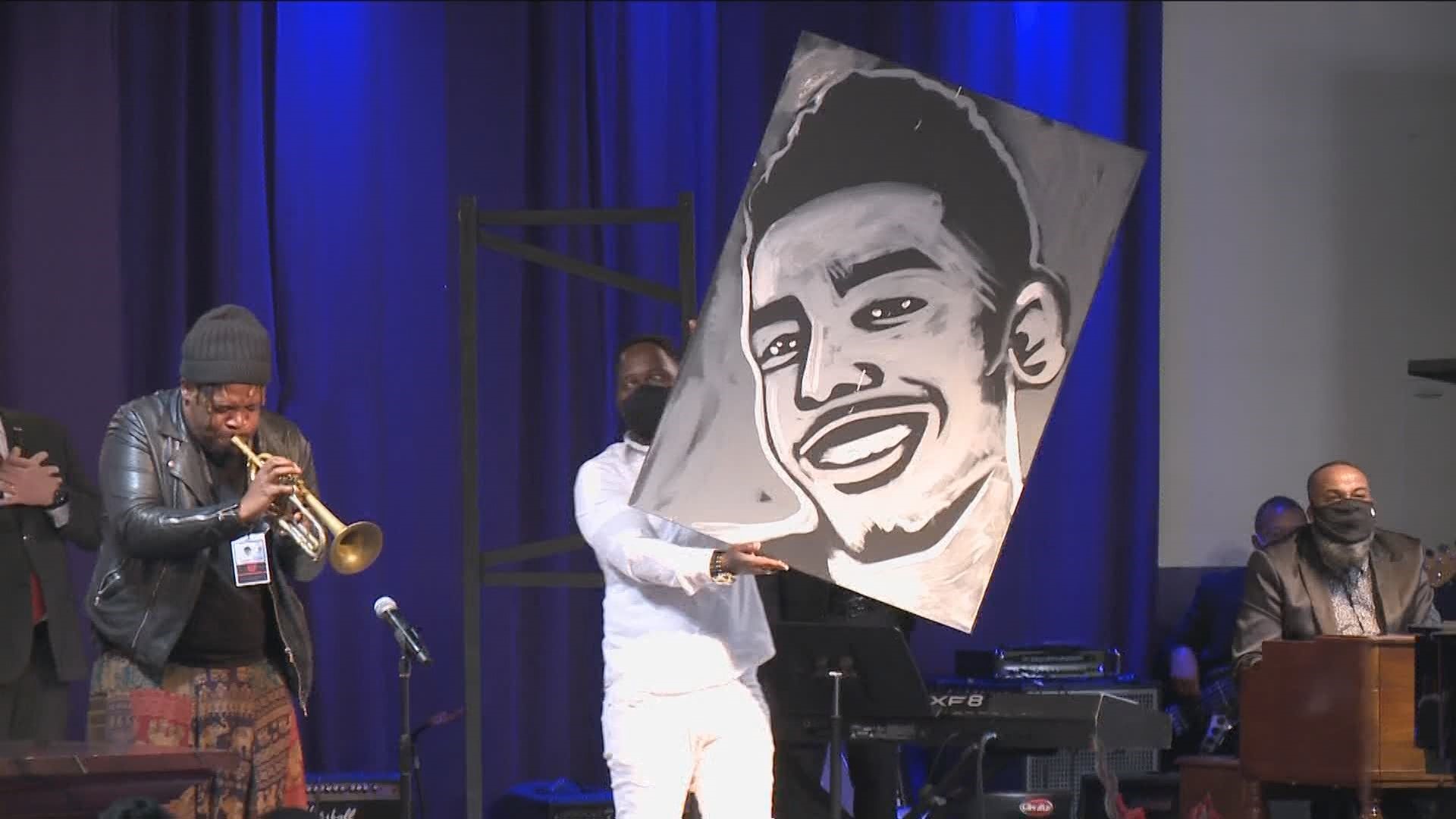 At Thursday's memorial service for Daunte Wright, trumpeter Keyon Harrold played as artist Ange Hillz painted a portrait of Wright on a canvas displayed on stage.