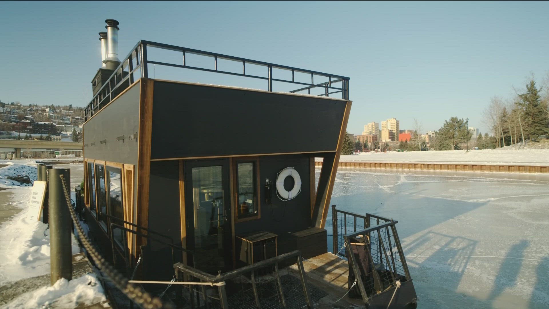 Surrounded by icy Lake Superior, the sauna is docked with the picturesque backdrop of the iconic lift bridge.