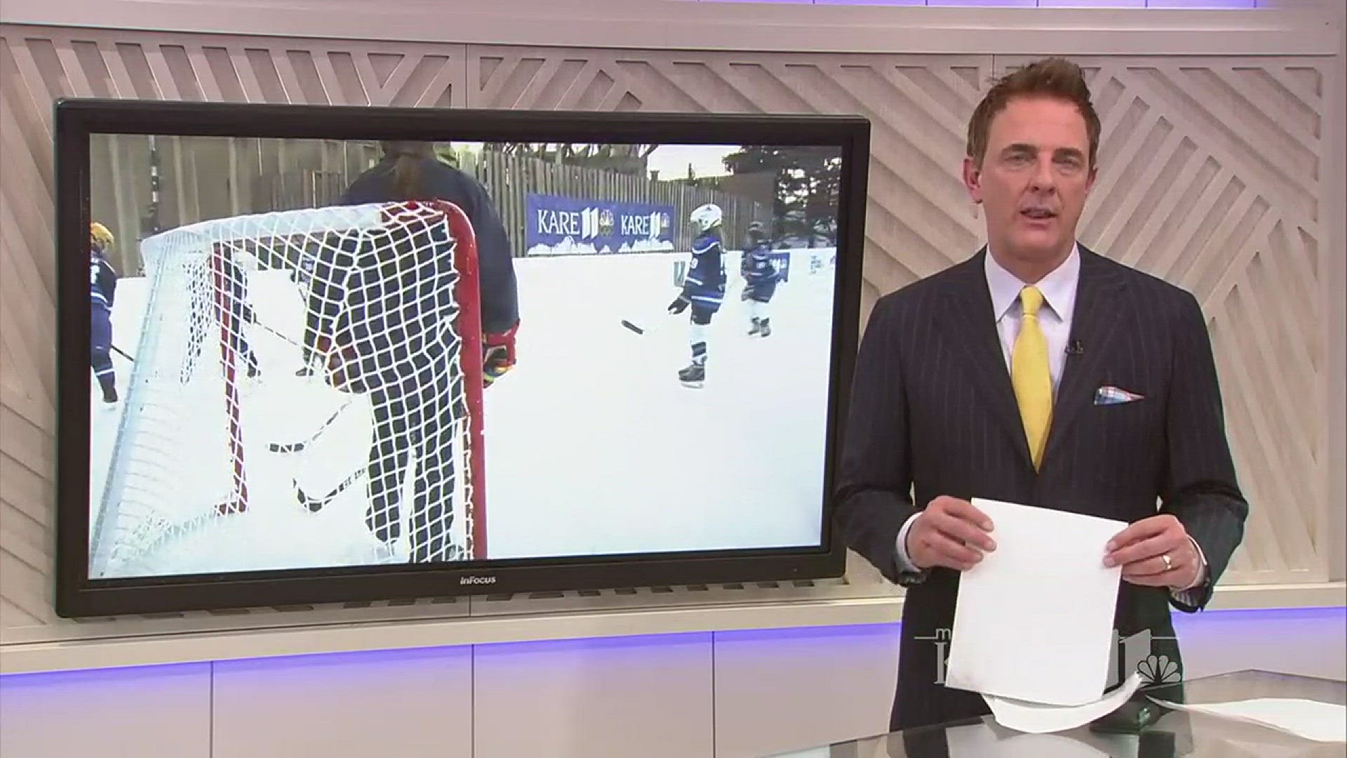 KARE 11 Sports Director Eric Perkins skates on the UCare rink with a local youth hockey team.