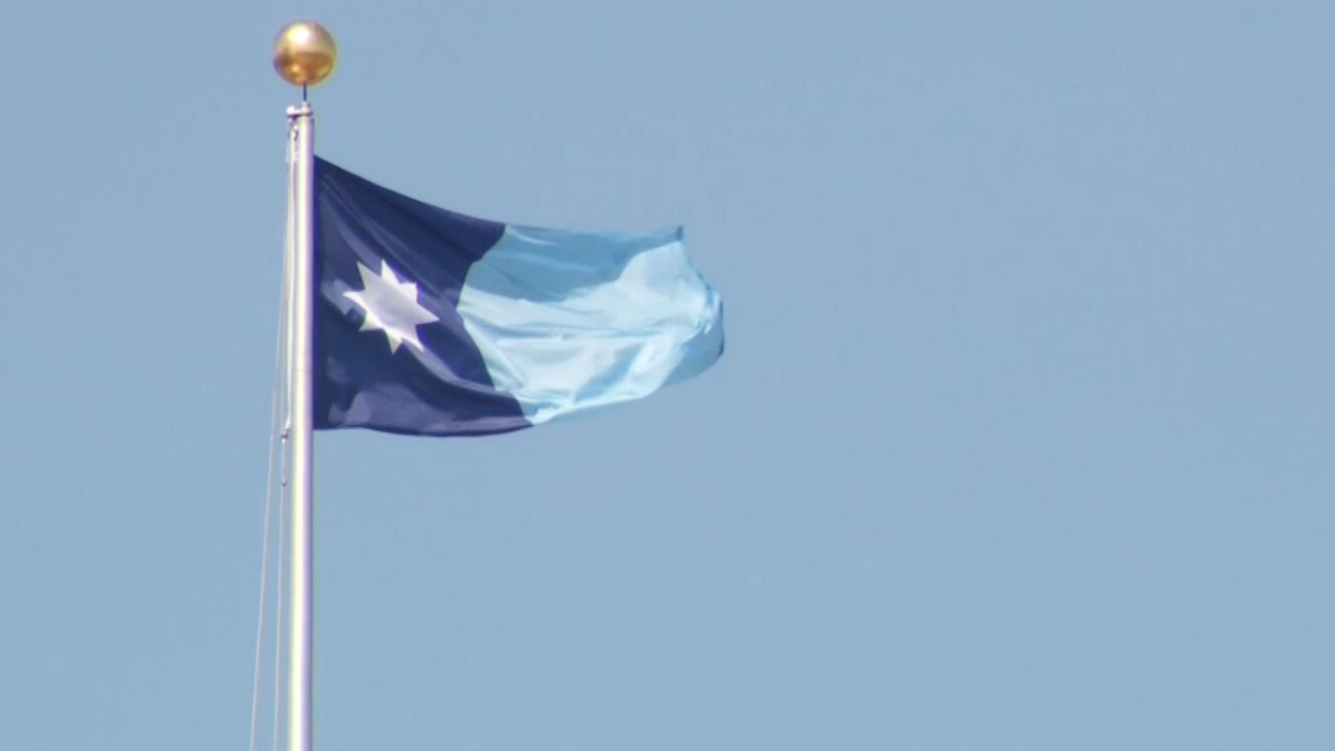 Minnesotans are displaying the new flag on Statehood Day--just hours after the redesigned banner and seal were officially adopted.