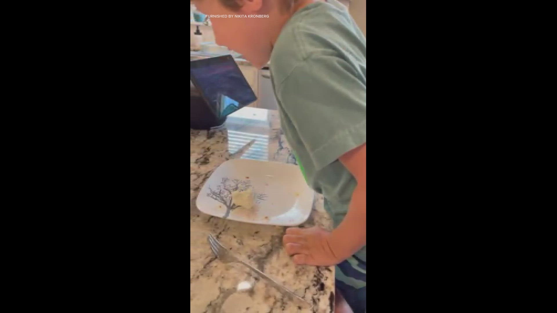 Home video of Eli Hart enjoying birthday cake frosting.