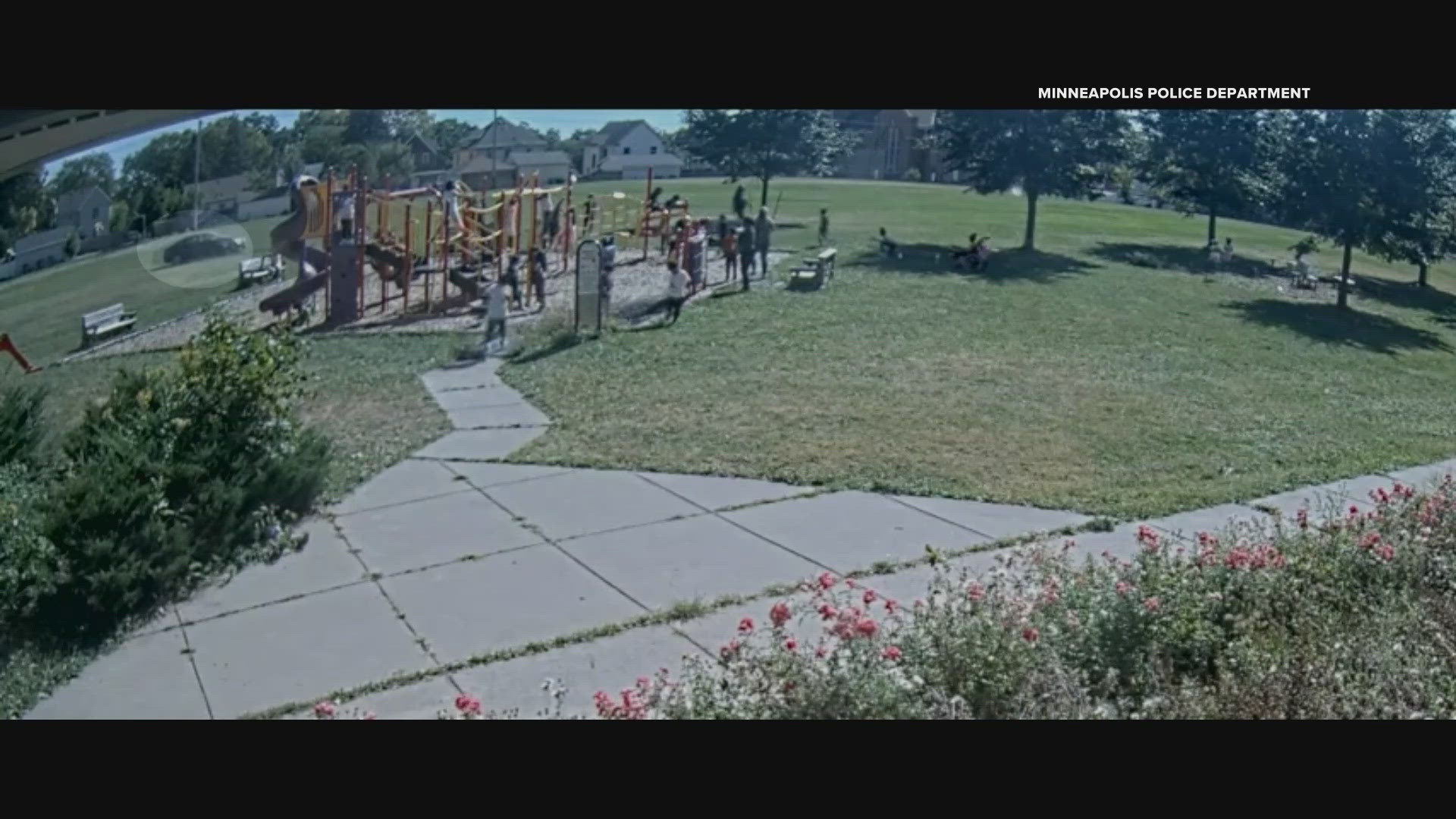 Surveillance video shows the car driving on the grass and sidewalk close by a busy playground.