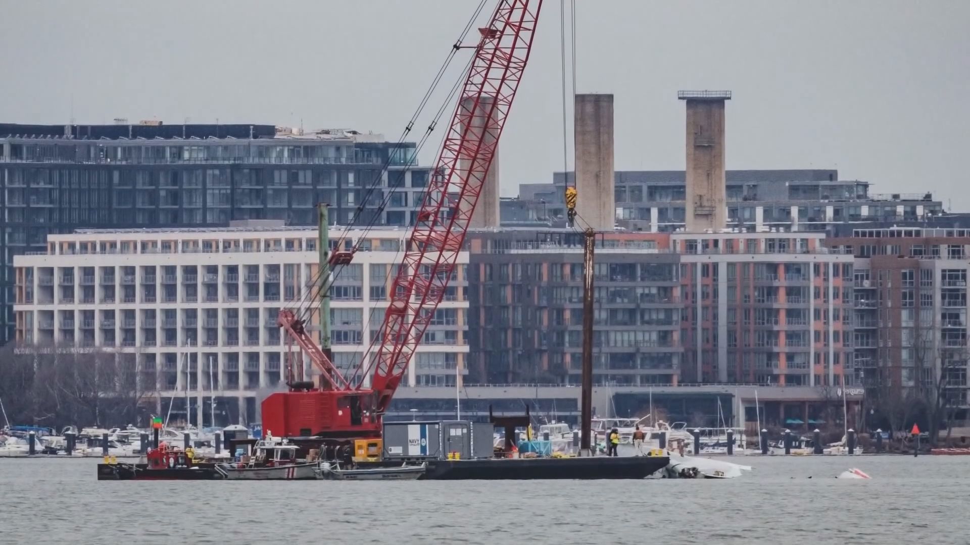 Special salvage cranes are in position to begin lifting wreckage of the American Airlines jetliner from the icy waters of the Potomac River.