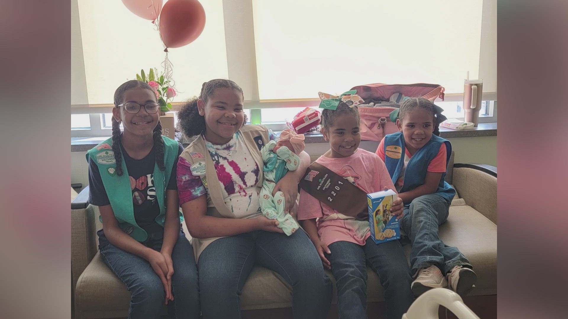 The Girl Scouts dressed the newborn baby up at the hospital with a Girl Scout vest and cookie onesie.