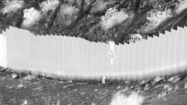Video captures suspected smugglers drop two young girls over 14-foot fence into US