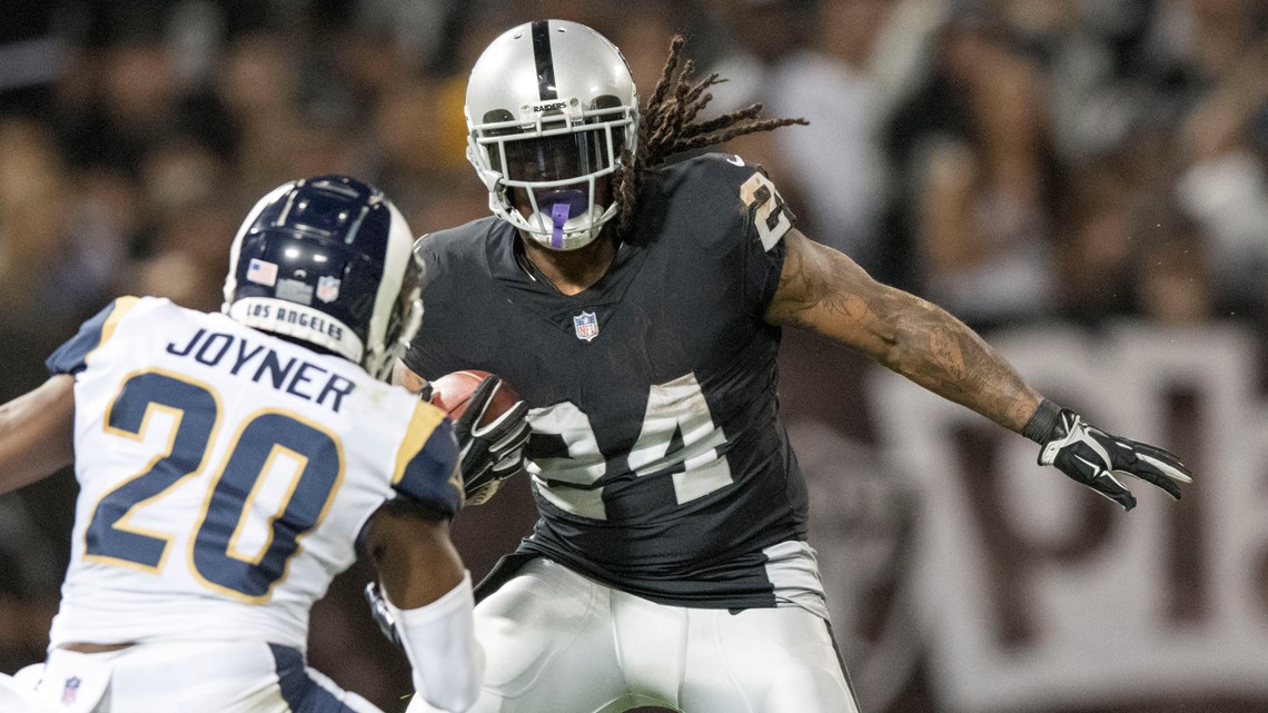 Raiders RB Marshawn Lynch sits during anthem before Rams game